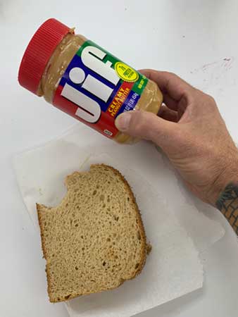 peanut butter and jelly sandwich and jar of JIF peanut butter